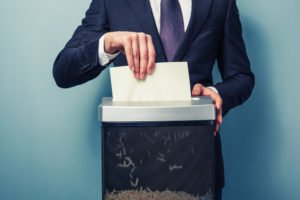 A businessman shredding evidence.