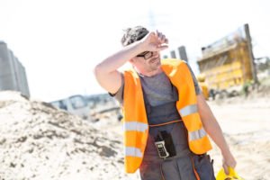 Construction worker looking tired while out under the sun