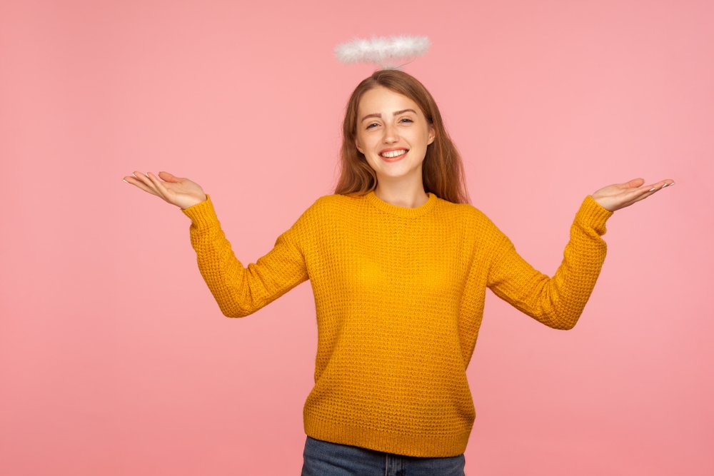 A woman with a halo over her head acting innocent.