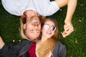 Man and woman smoking a joint outside in violation of HS 11362.3.
