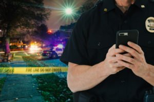 A police officer searching a suspect's cell phone.