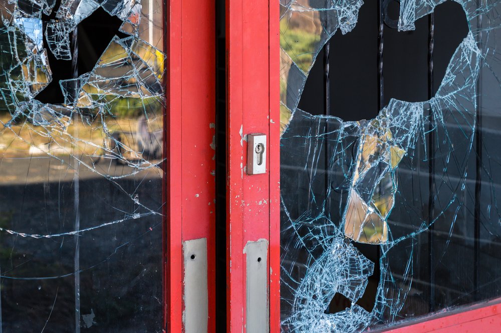 A vandalized window, possibly resulting in a felony charge depending on the value of the damage incurred.