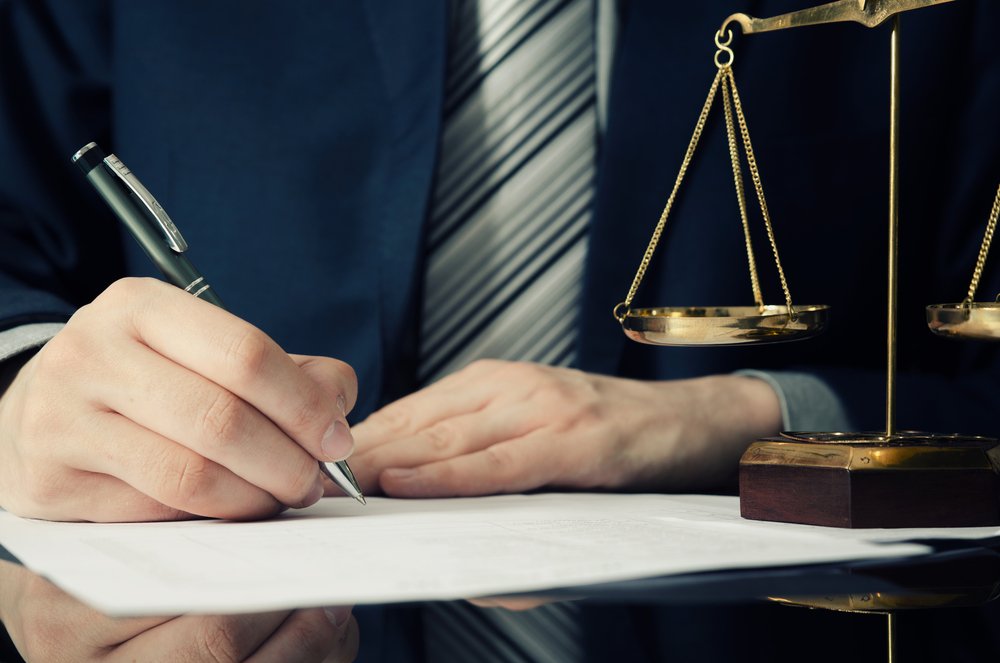 An attorney signing an Attorney Representation Letter for his client.