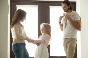 Dad dropping off daughter with Mom as part of a joint custody arrangement