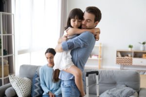 Father saying goodbye to child after dropping her off to mom in joint custody arrangement