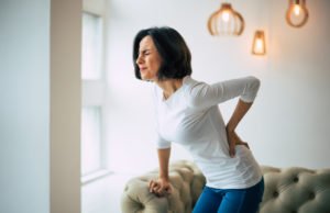 A woman experiencing excruciating lower back pain.
