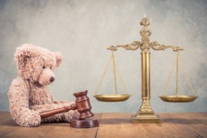 Scale with teddy bear holding a gavel