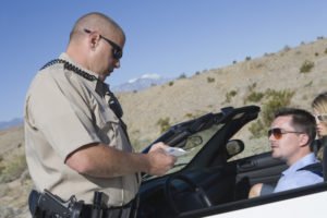 Officer writing civil infraction ticket to motorist
