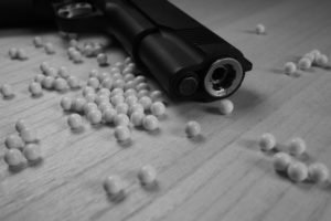 BB gun with bb pellets on the ground