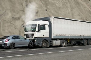 Aftermath of collision between large truck and sedan