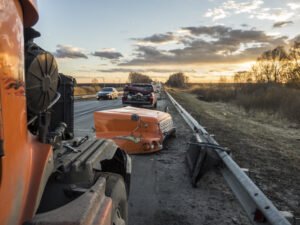 A totaled truck on the side of the road after an accident