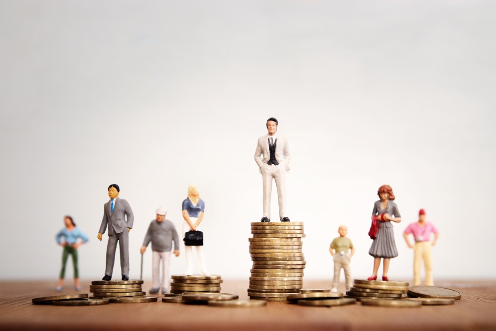 A conceptual piece representing wage discrimination, featuring members of different genders and age groups standing on differing amounts of money.