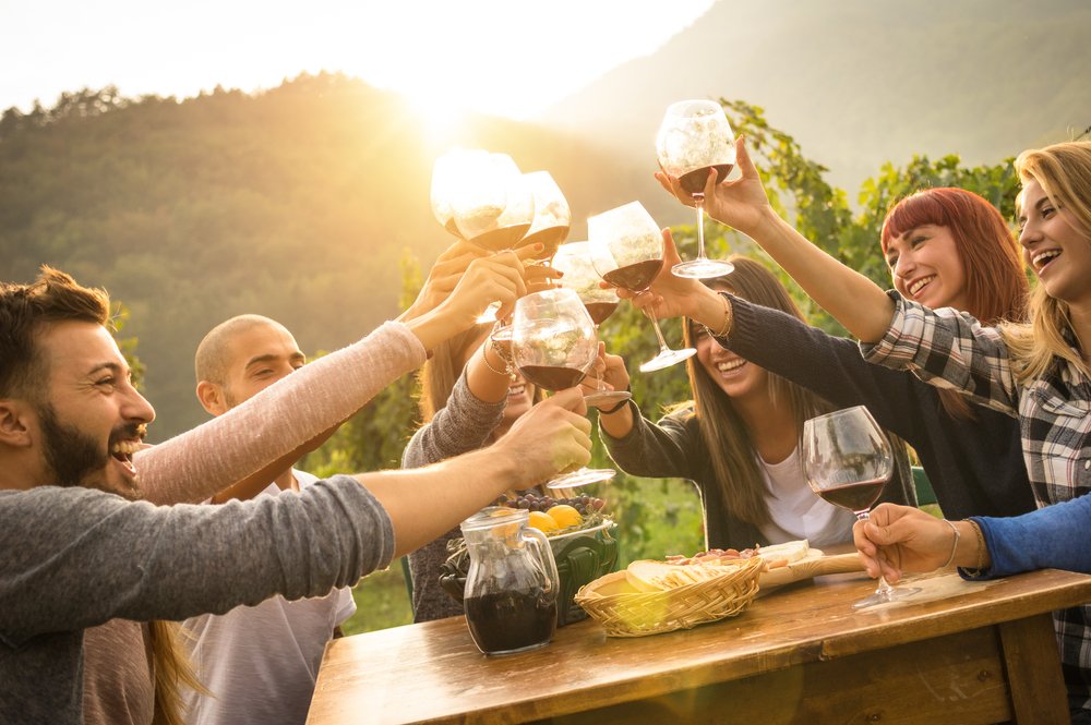 A group of friends enjoying a day out together with glasses of wine. They will hopefully be careful to avoid drinking too much and potentially getting a DUI.