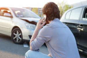 A man on the phone with his lawyer after a DUI related car crash not involving an injury.