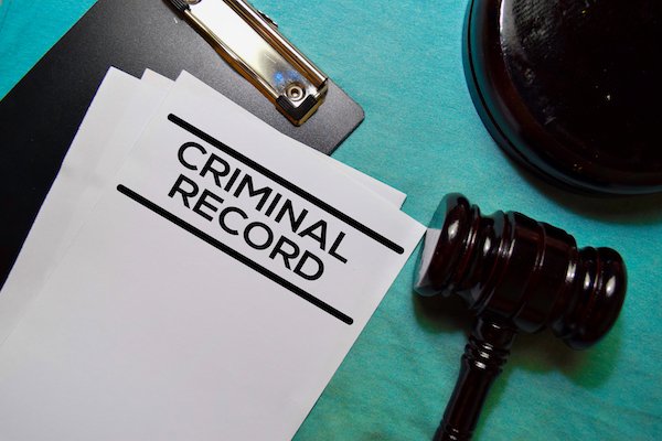 Clipboard that says "criminal record" next to a gavel