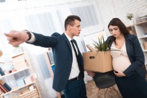 Interior of a corporate office building: pregnant employee is fired by angry boss