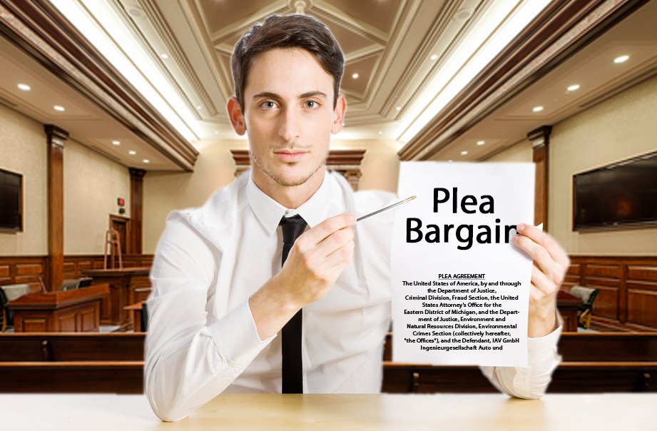 Interior of a modern courtroom. A young male attorney in business attire holds a piece of paper that says "Plea Bargain", he points to the piece of paper with a pen.