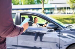 Conductor de Uber recogiendo a un pasajero con su teléfono
