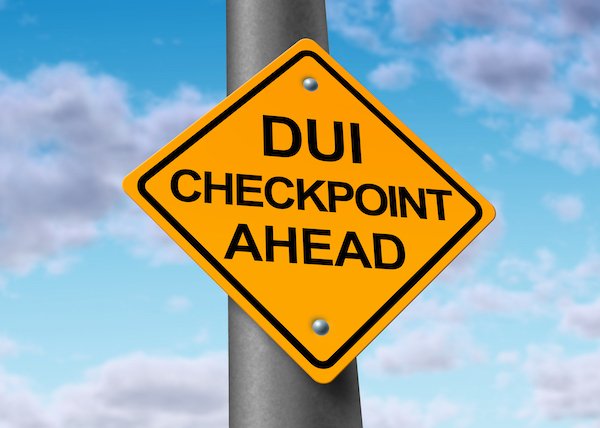 Yellow sign that says "DUI checkpoint ahead"