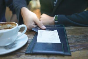 A businessman is paying his bill by credit card at the restaurant.