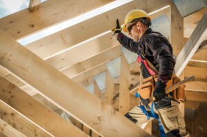 Man in hard hat fixing his own roof in accordance with NRS 624.700.