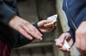 Close-up of hand-to-hand drug sale