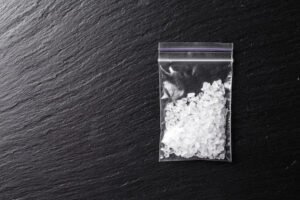 Bag holding meth against black table