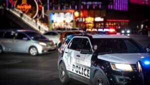Las Vegas police cars in front of a casino at night during an extradition raid