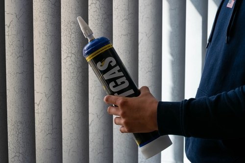 A man holding a nitrous oxide containter