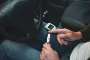 Diabetic in car testing his blood