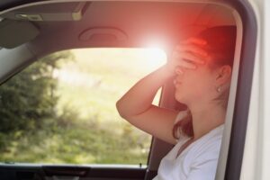 Epileptic holding her head in a car