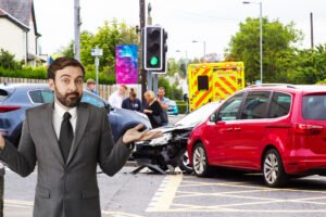 man shrugging shoulders in front of multi-vehicle crash