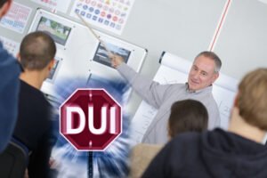 A teacher instructs the students of a DUI class