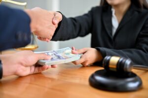 A client hands money to their lawyer