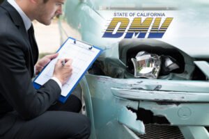 man fills out form while looking at damage from car crash, DMV logo