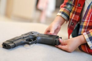 Child holding a revolver