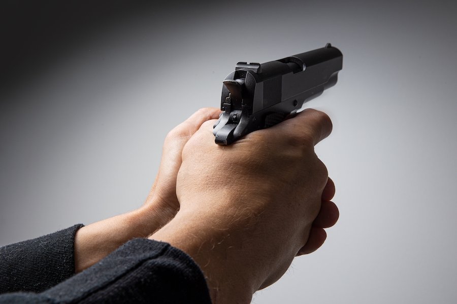 Close-up of hands holding a gun