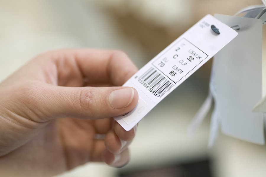 Closeup of hand about to alter a price tag in violation of NRS NRS 205.965