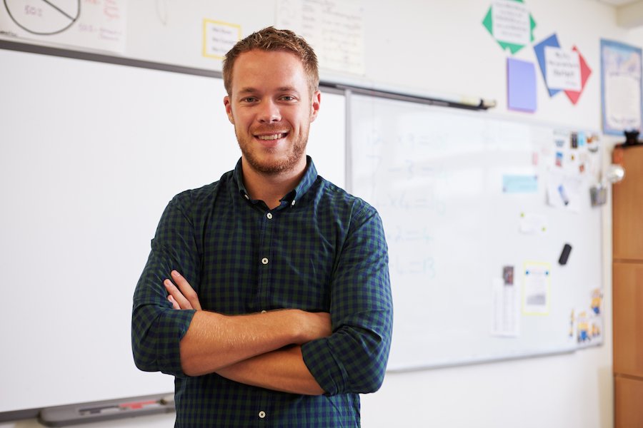 Teacher standing in front of a white board