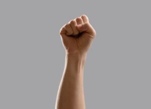 Photo of hand in a fist to signify a punch ("battery") about to happen