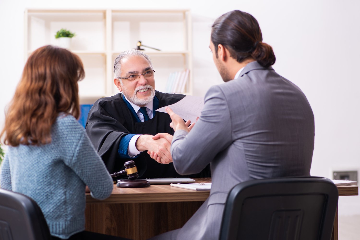 Judge shaking the hands of an attorney following a win in court