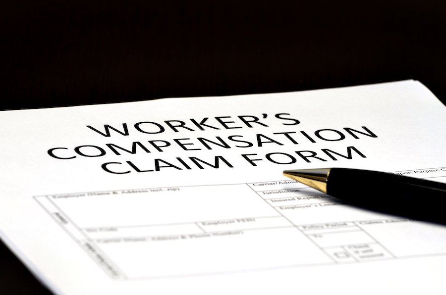 Closeup of form with the title, "Worker's Compensation Claim Form" with a pen resting on it
