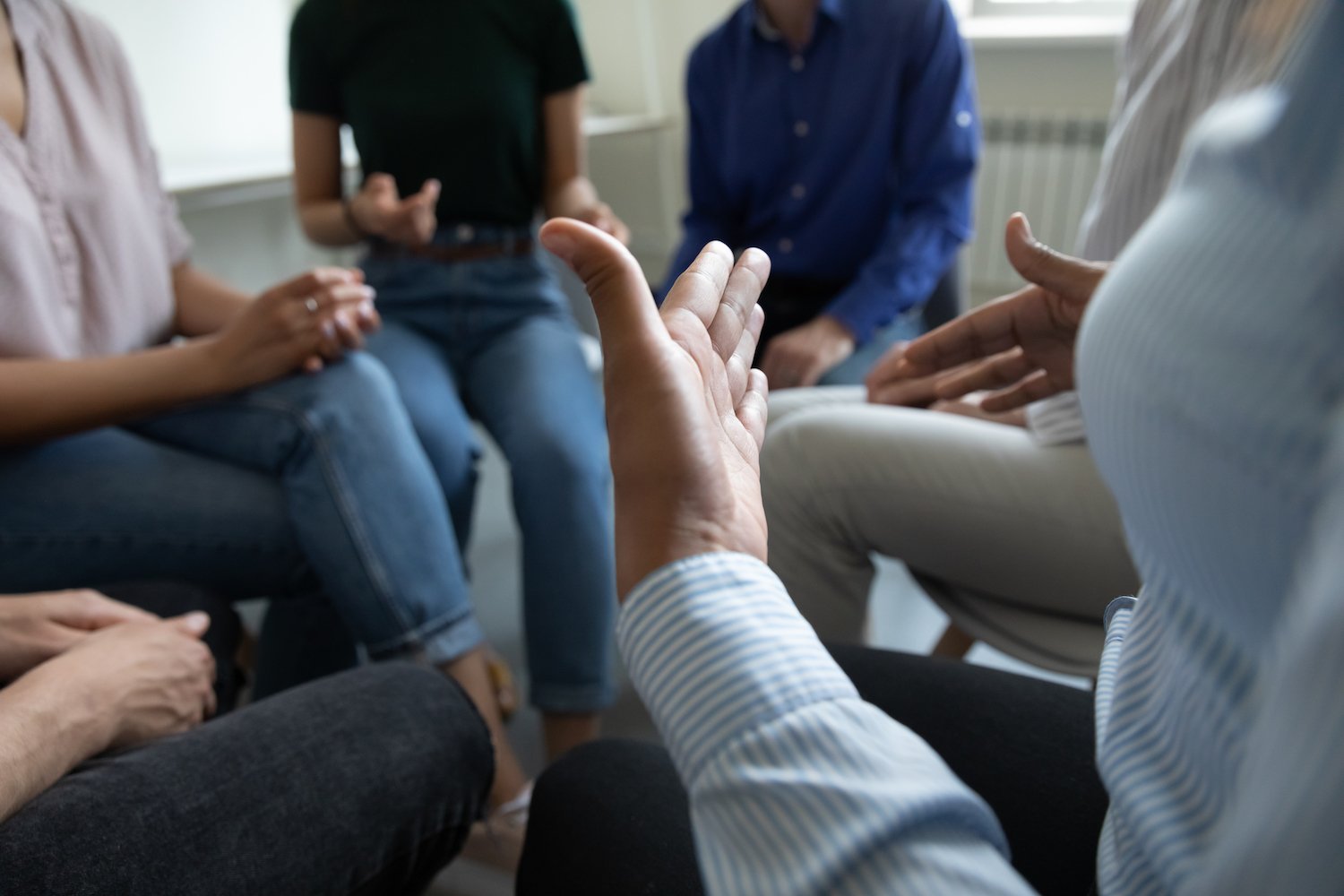 Group counseling session with patients sitting in a circle with a counselor