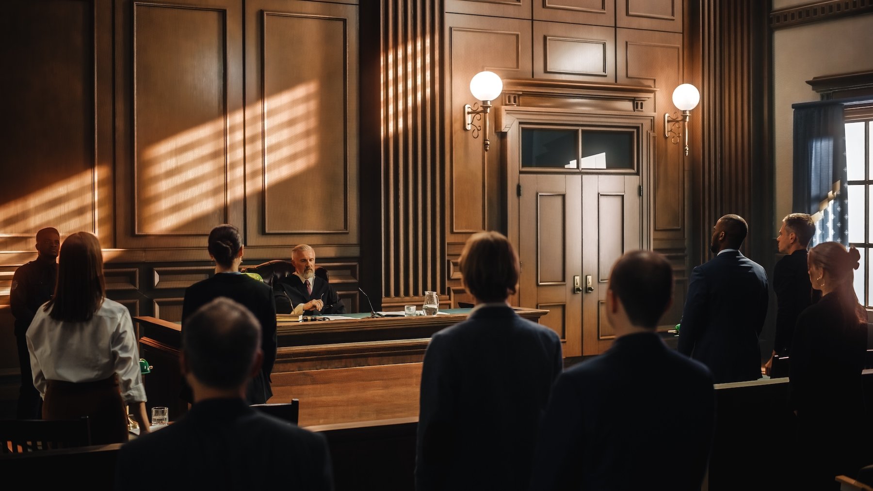 Wooden courtroom with everyone standing after the judge arrived