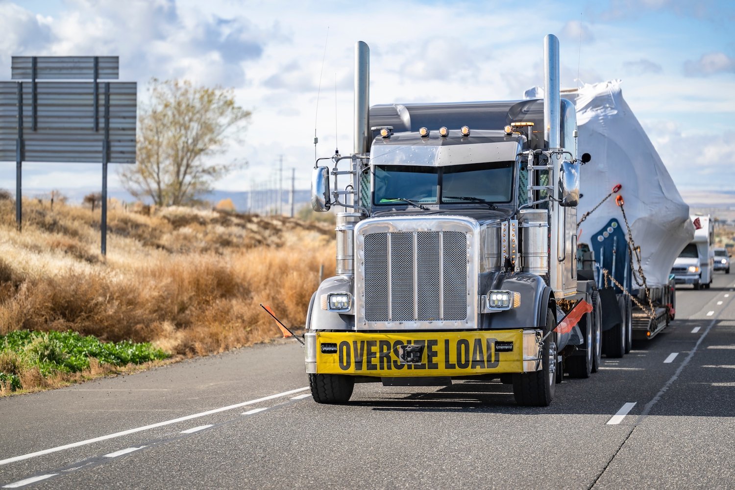 Oversized Load truck on a rural road during the daytime