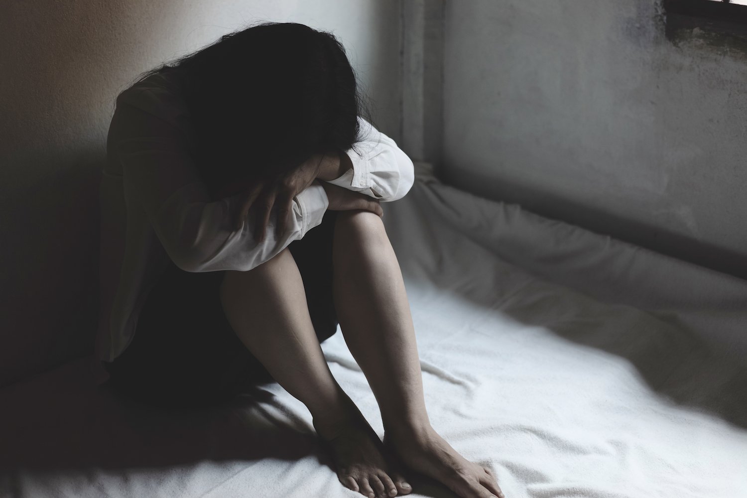 Female victim on a bed following a sexual assault