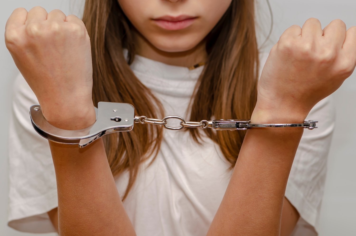 Teenage girl in handcuffs after being arrested in California