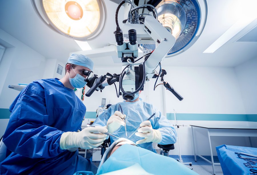Brain surgery in process of two surgeons operating on a patient's meningioma 
