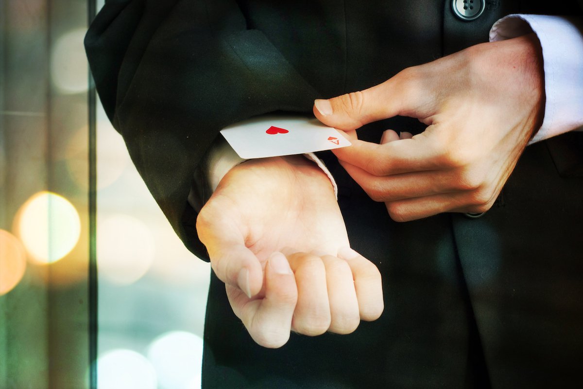 Man taking an ace of hearts out of his jacket cuff with the intent to cheat at gambling in violation of NRS 465.083