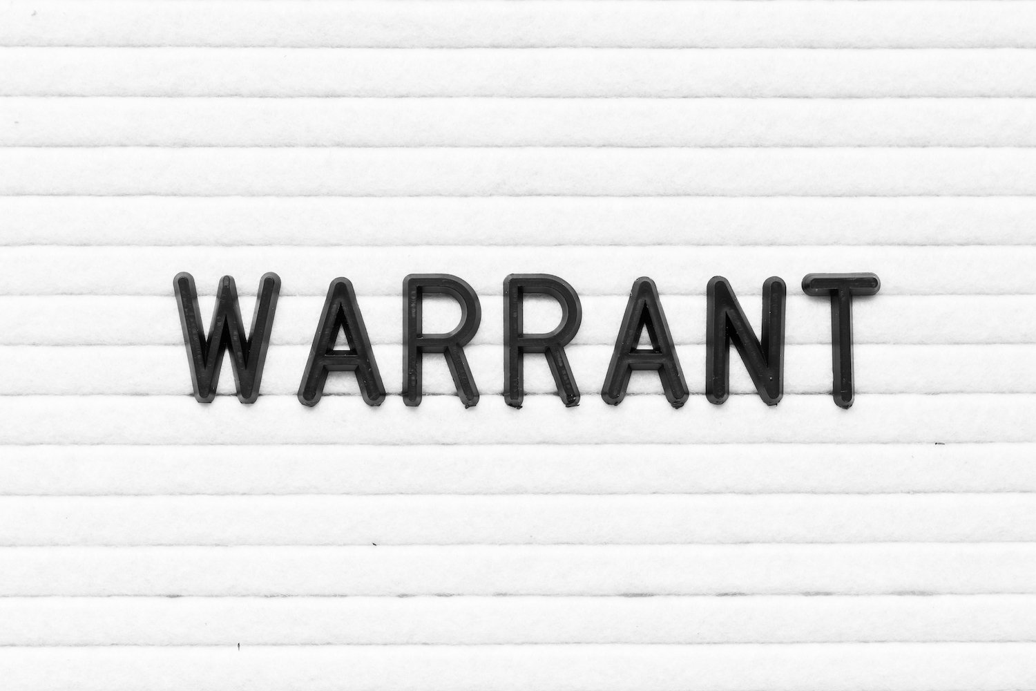 White background that says "Warrant" in black letters